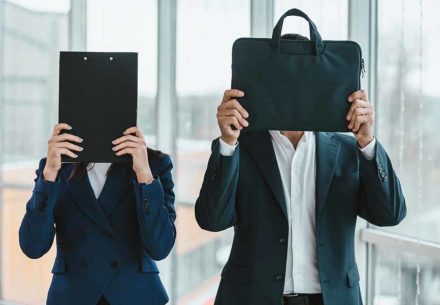 Man and woman hiding their faces