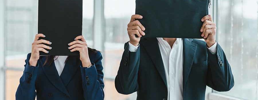 Man and woman hiding their faces