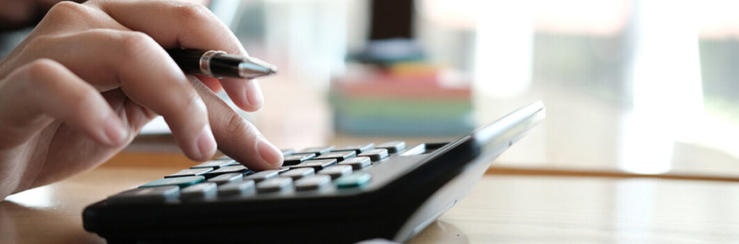 a person running numbers on a calculator.