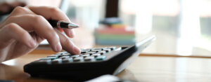 a person running numbers on a calculator.