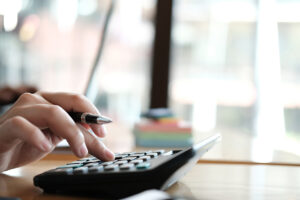 a person running numbers on a calculator.