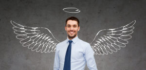 a businessman with a drawing of wings and a halo behind him.