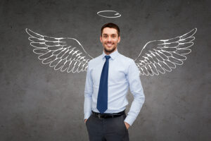 a businessman with a drawing of wings and a halo behind him.
