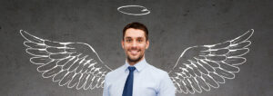a businessman with a drawing of wings and a halo behind him.