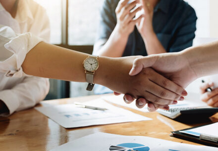 two businesspeople shaking hands signaling an agreement.