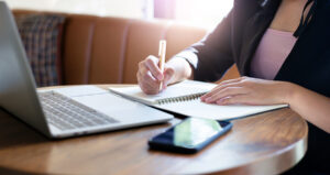 a businesswoman writes a small business plan.