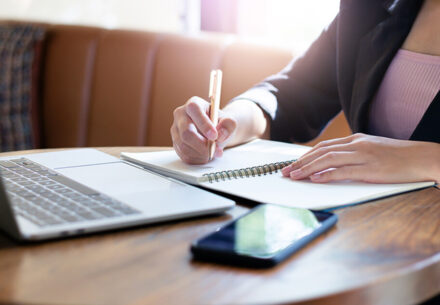a businesswoman writes a small business plan.