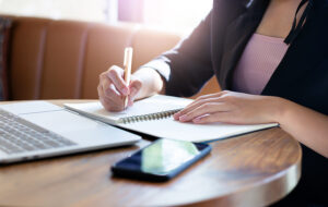 a businesswoman writes a small business plan.