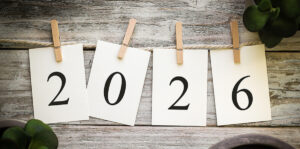 four individual sheets of paper on a clothesline hanging by clothespins that spell out 2026.