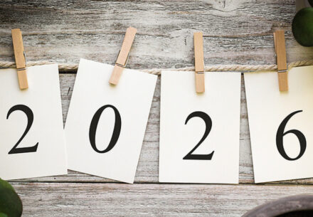 four individual sheets of paper on a clothesline hanging by clothespins that spell out 2026.