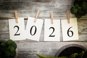 four individual sheets of paper on a clothesline hanging by clothespins that spell out 2026.