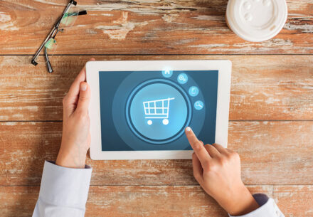a person points to a general online retail symbol on a tablet computer.
