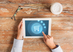 a person points to a general online retail symbol on a tablet computer.