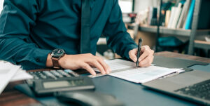 an accountant looks at papers on his desk.