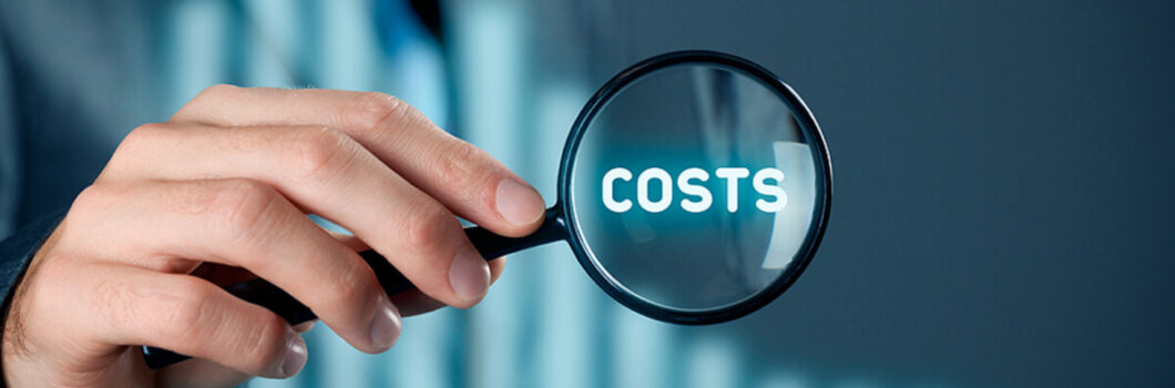 a businessman puts a magnifying glass over the word costs.