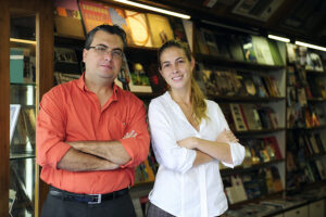 a father and daughter working at a bookstore.
