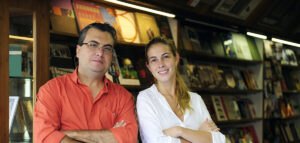 a father and daughter working at a bookstore.