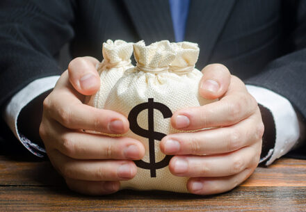 a lender handing over a couple small bags of money.