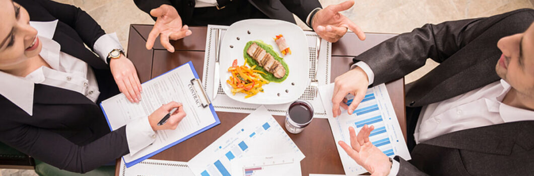 people sitting down to a business meal.