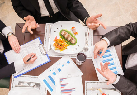 people sitting down to a business meal.