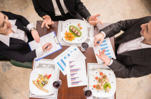 people sitting down to a business meal.