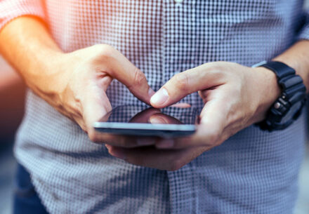 a man uses a smartphone.