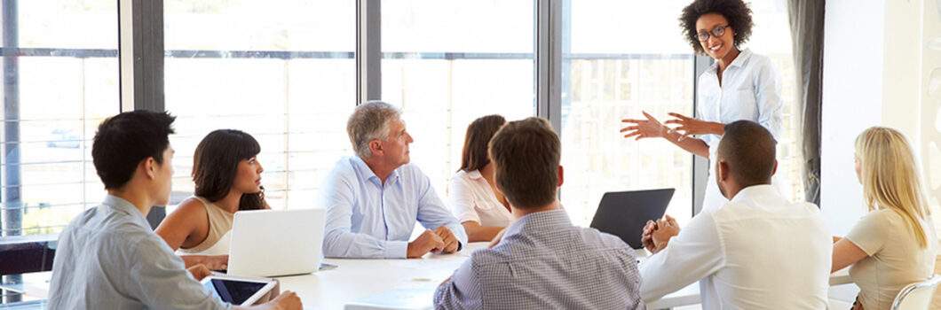 A nonprofit board member presenting to colleagues at a meeting.